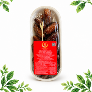 A tray of brown dates in clear plastic wrapping with a red label, on a white background framed by illustrated green leaves.