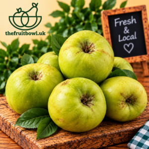 British Bramley Apples displayed on rustic wood with green foliage
