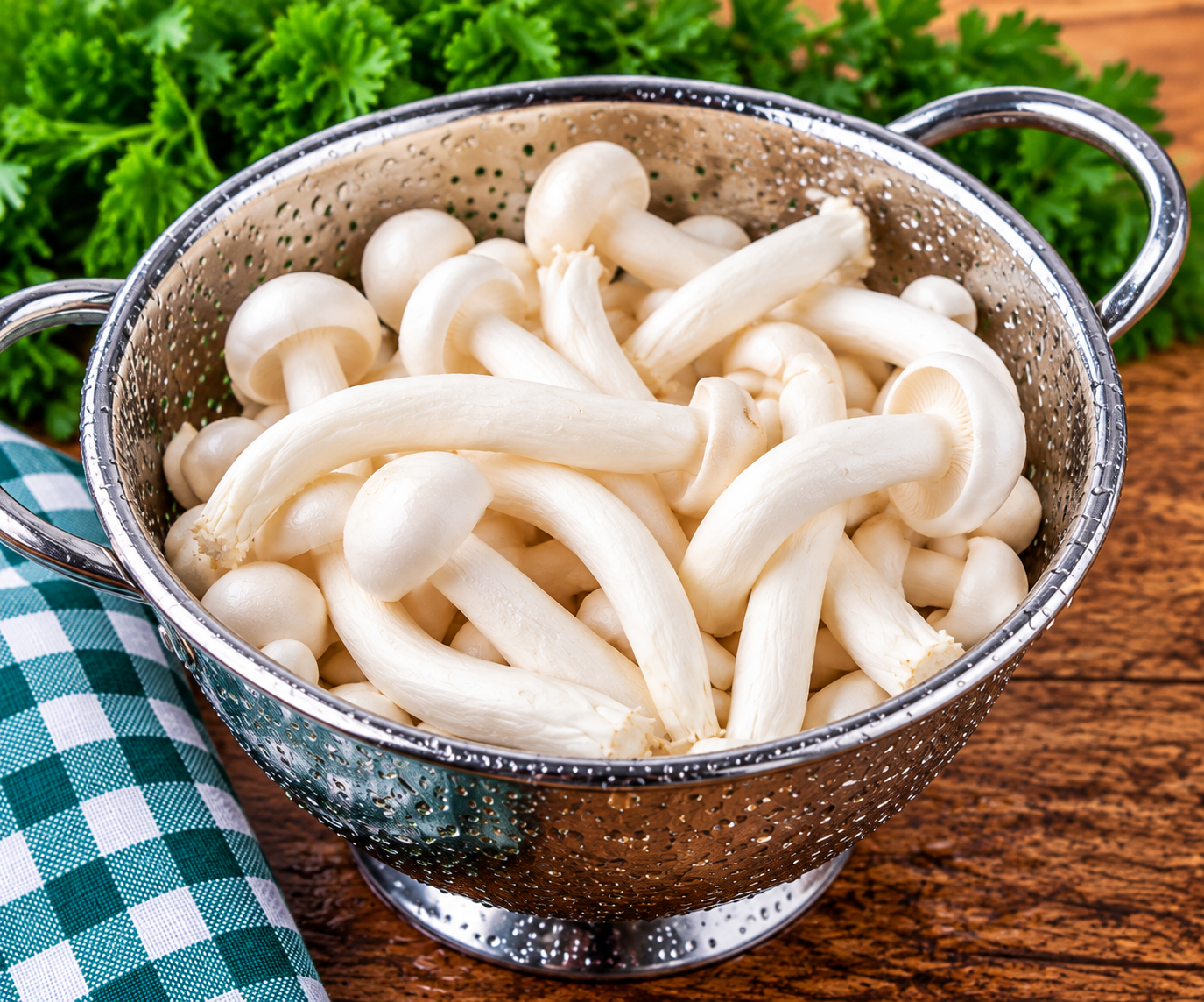 Freshly washed White Shimeji Mushrooms in a metal colander
