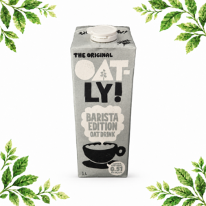 A grey 1 litre carton of Oatly Barista Edition Oat Drink on a white background with green leafy corners.
