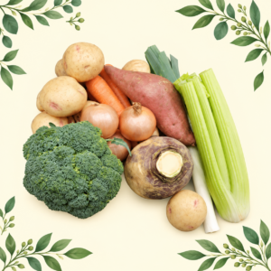 Vegetable selection with potatoes, carrots, onions, broccoli, sweet potato, swede, leek and celery on a cream leafy background.