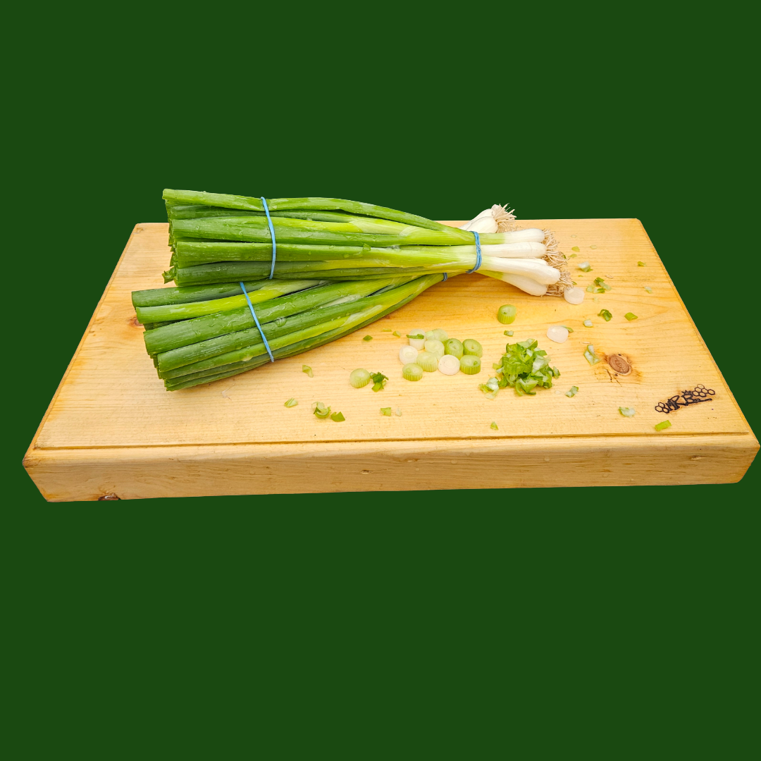 Fresh Spring Onions on chopping board ready for cooking